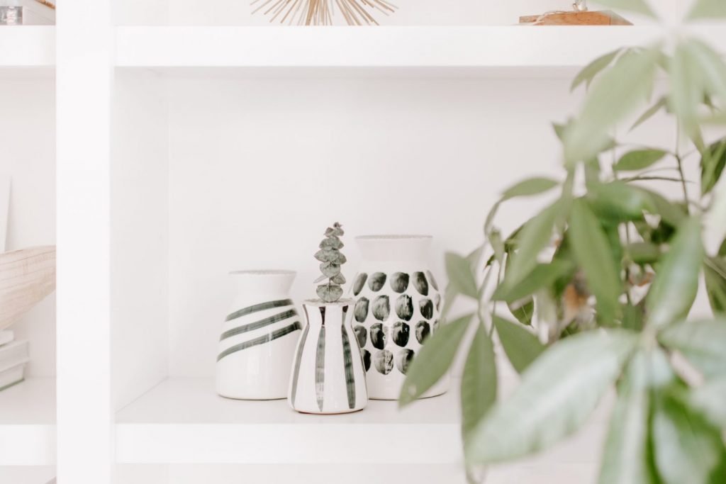 Various Decorations on a White Wooden Shelf