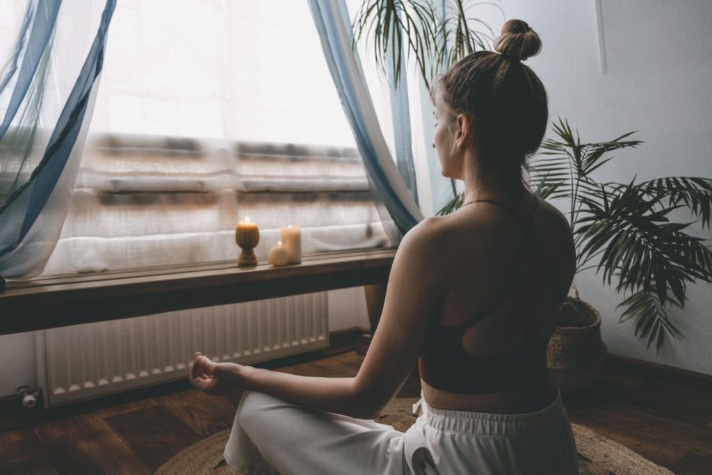 person meditating at home
