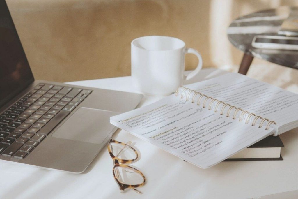 laptop next to notebook