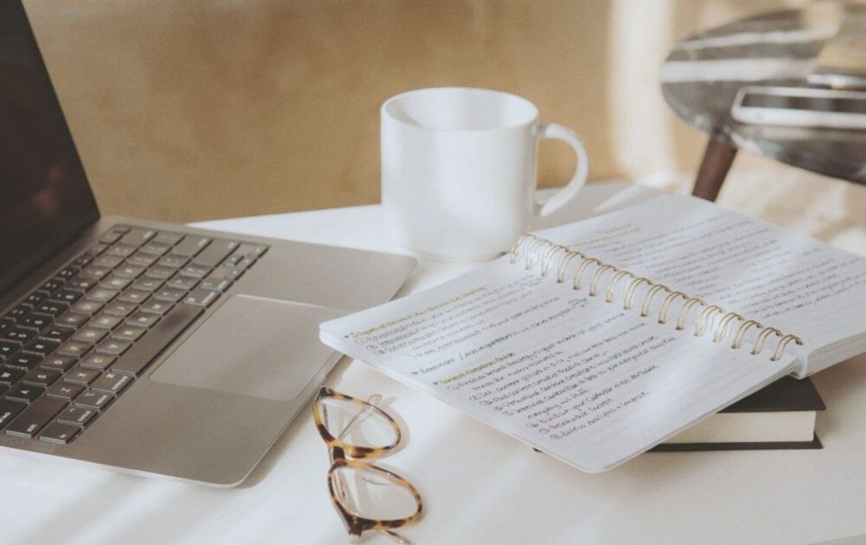 laptop next to notebook