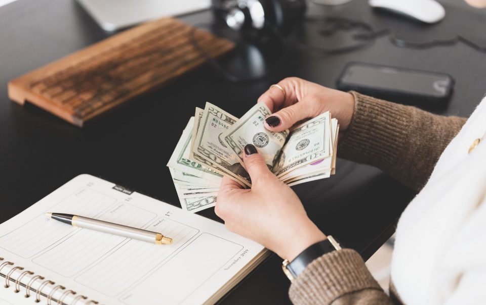person counting cash money