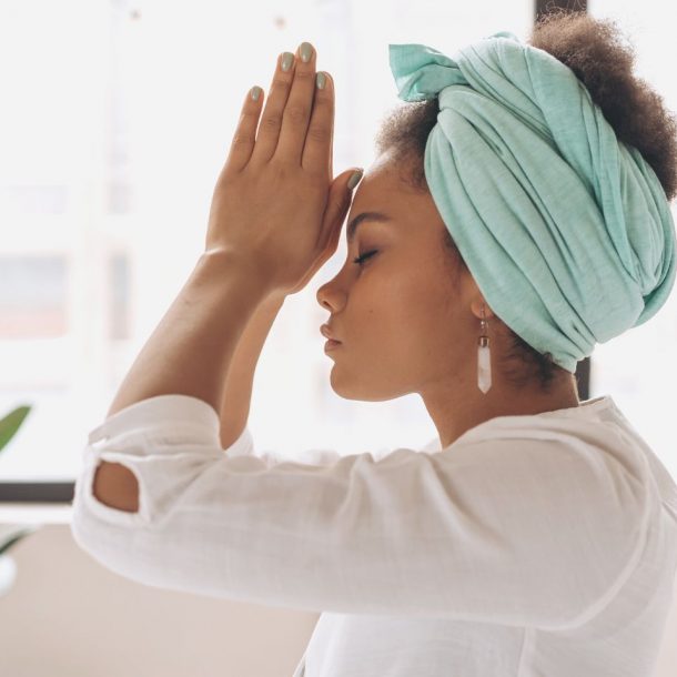 woman in white long sleeve shirt with blue towel on head