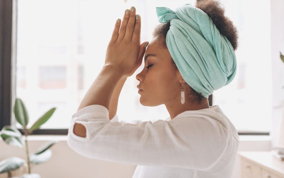 woman in white long sleeve shirt with blue towel on head