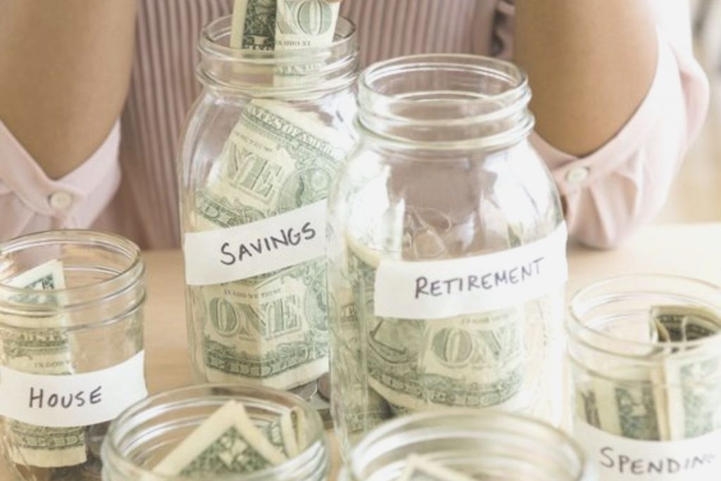money in multiple jars with diiferent labels