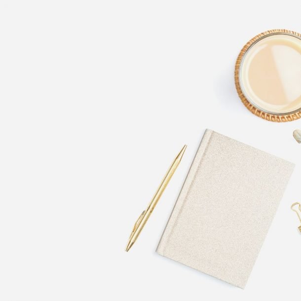 closed journal next to candle on desk