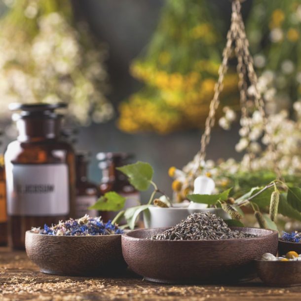 herbs medicine, natural remedy and mortar on vintage wooden desk