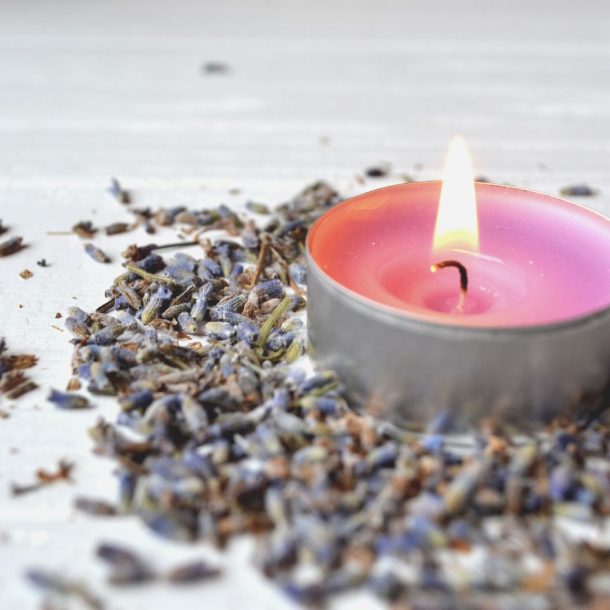 lavender flavor. violet candle in lavender flowers. lavender aromatherapy.